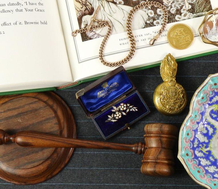 Medals, porcelain and a pocket watch on the valuation table