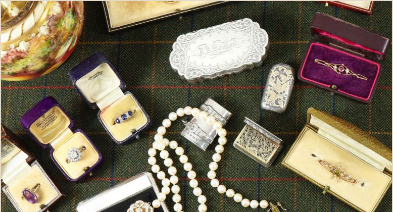 A collection of jewellery and silver laid out for valuation