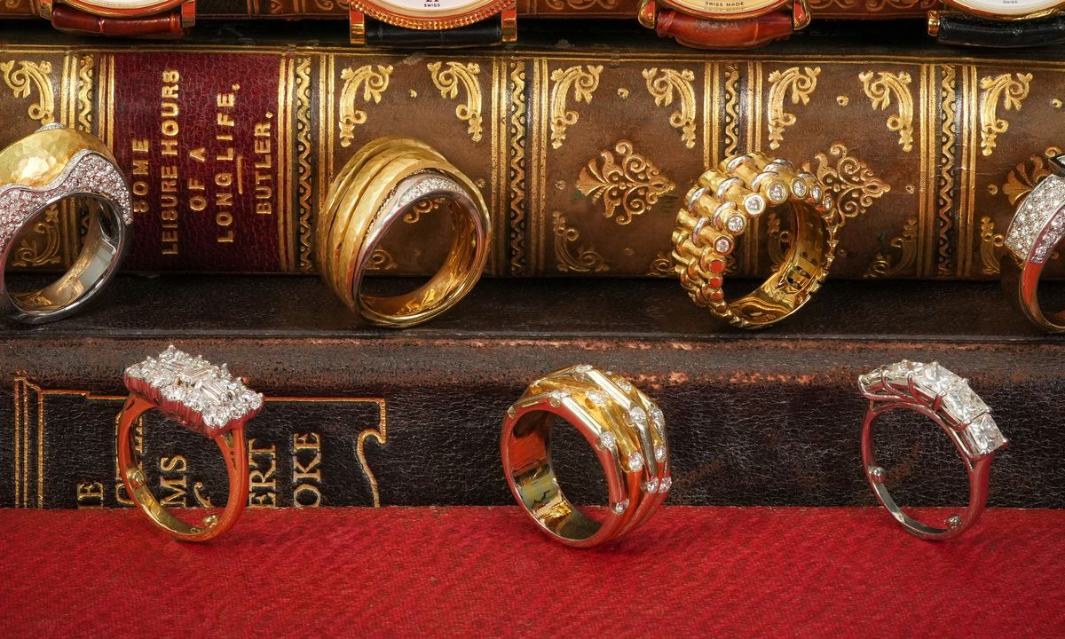 Gold and diamond rings displayed on antique books