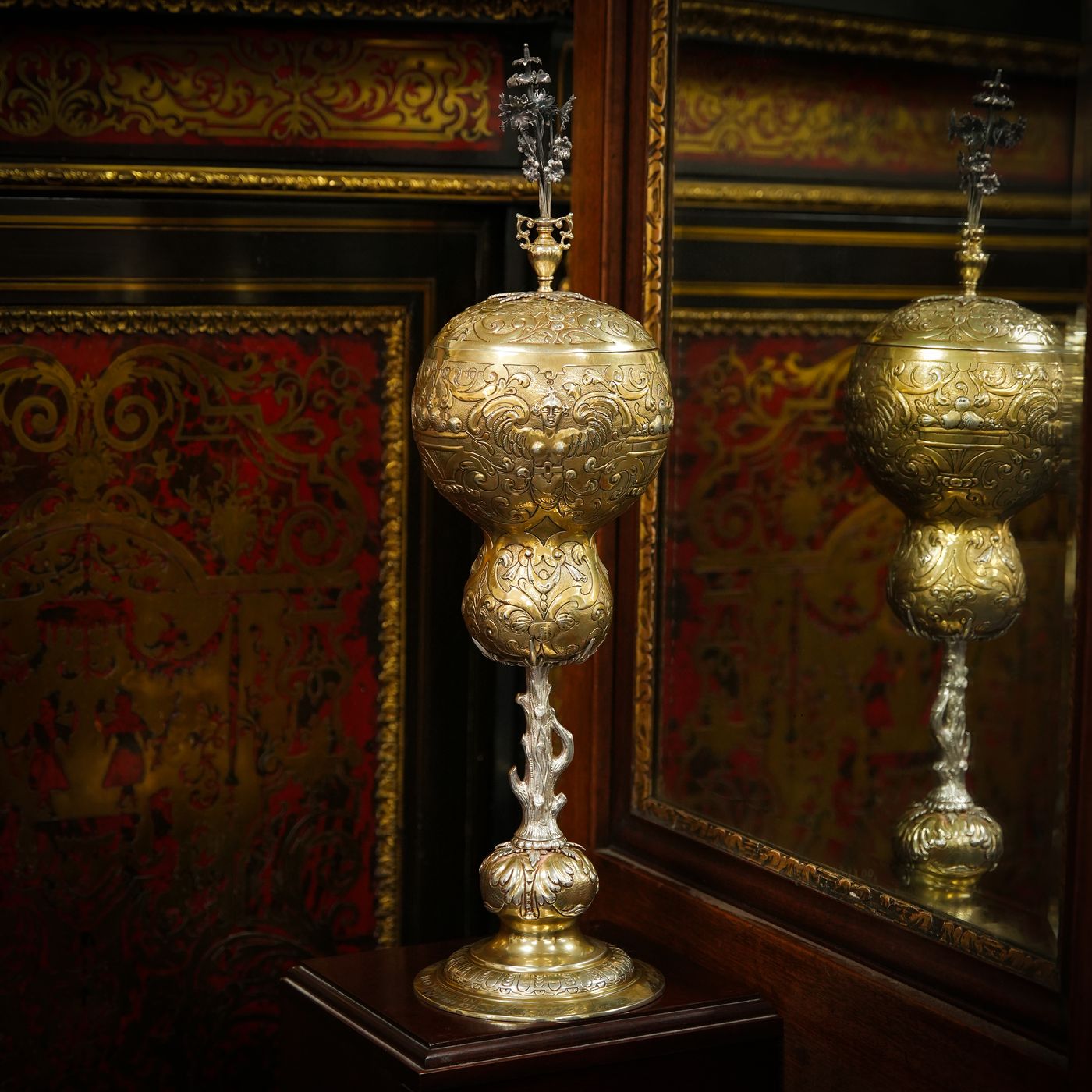 Silver gilt cups in a cabinet at the saleroom