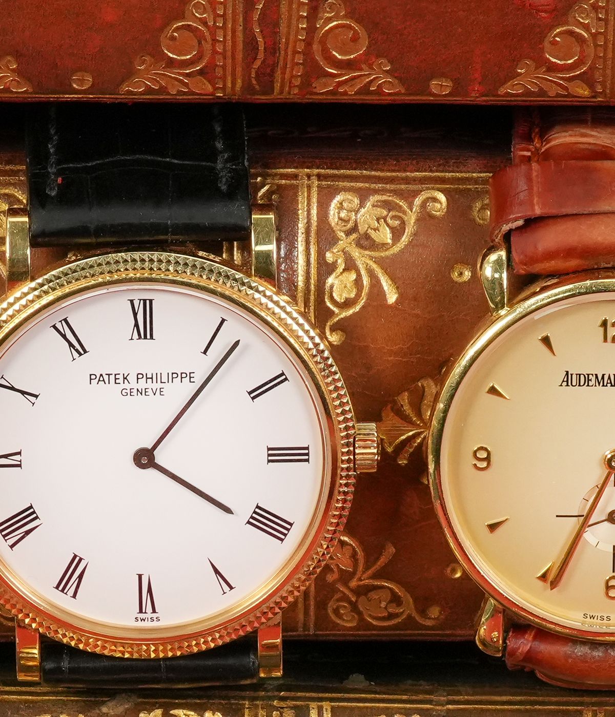 Patek Philippe and Audemars Piguet wristwatches on antique books